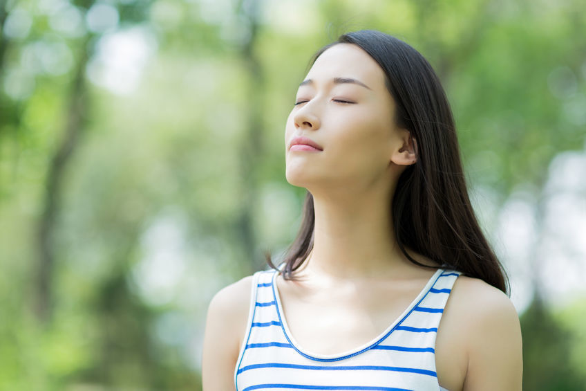 an image of a woman sun basking in the park